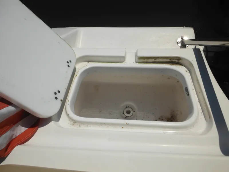 Slide: The Image of Open storage compartment on 2022 Tidewater 220 LXF boat, showing interior details. - 16
