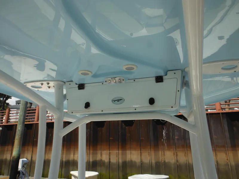 Slide: The Image of 2022 Tidewater 220 LXF boat interior view with blue ceiling and storage compartment. - 18