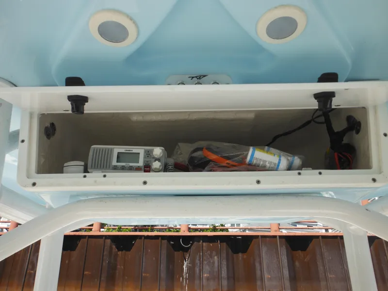 Slide: The Image of Storage compartment of 2022 Tidewater 220 LXF boat with radio and accessories. - 19