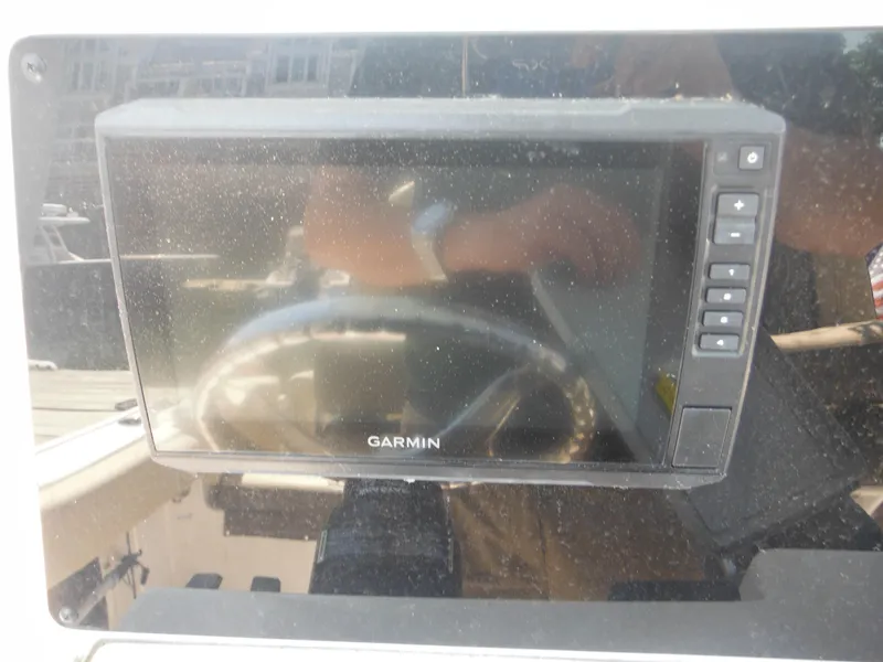 Slide: The Image of Garmin display on 2022 Tidewater 220 LXF boat dashboard, reflecting surroundings. - 24