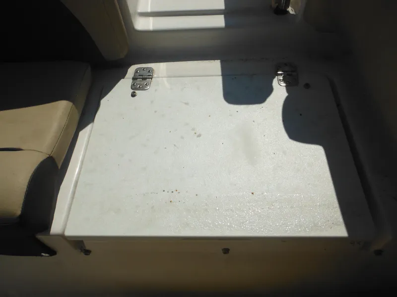 Slide: The Image of 2022 Tidewater 220 LXF boat interior with storage compartment and seating. - 27