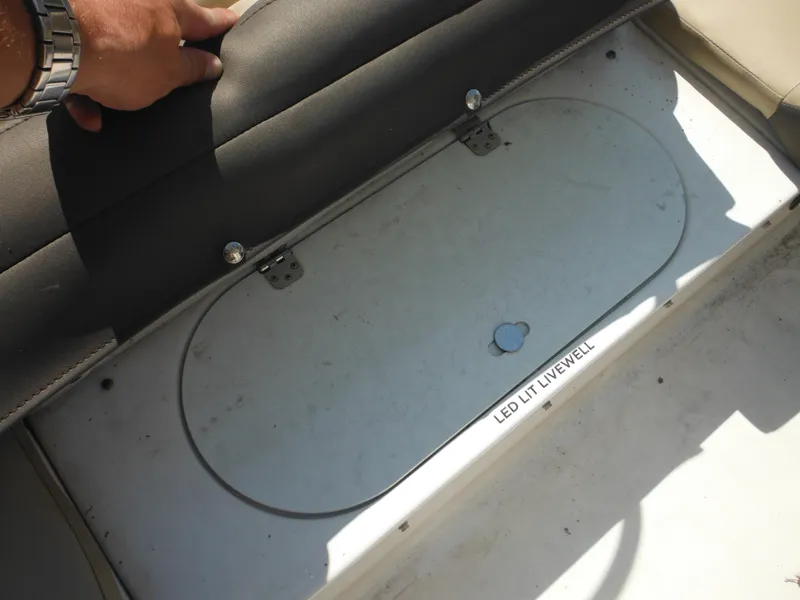 Slide: The Image of 2022 Tidewater 220 LXF boat's LED-lit livewell compartment under seat. - 29
