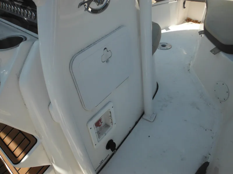Slide: The Image of 2022 Tidewater 220 LXF boat interior, featuring console and seating area. - 33