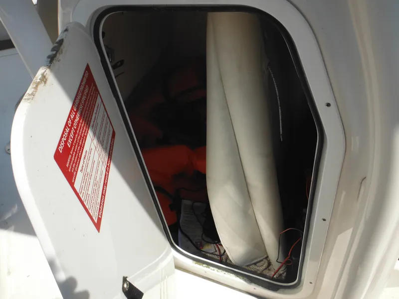 Slide: The Image of Open storage compartment on 2022 Tidewater 220 LXF boat, showing interior contents. - 36