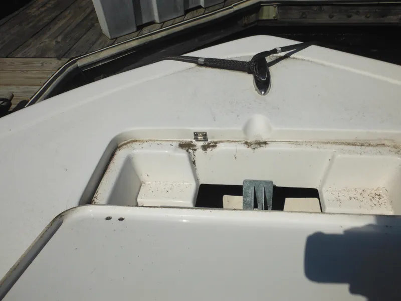 Slide: The Image of 2022 Tidewater 220 LXF boat anchor compartment with visible wear and dirt. - 41