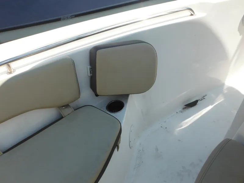 Slide: The Image of 2022 Tidewater 220 LXF boat interior with cushioned seating and cup holder. - 43