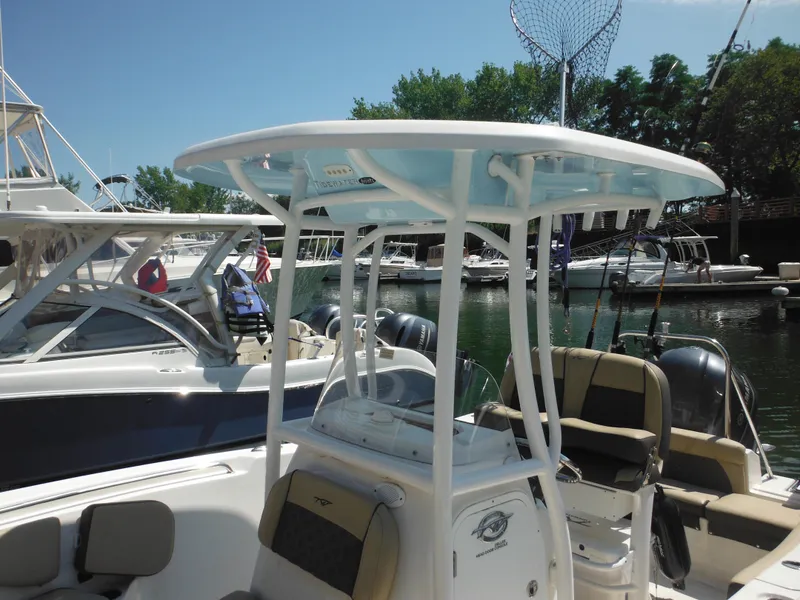 Slide: The Image of 2022 Tidewater 220 LXF boat docked at marina with fishing gear. - 6