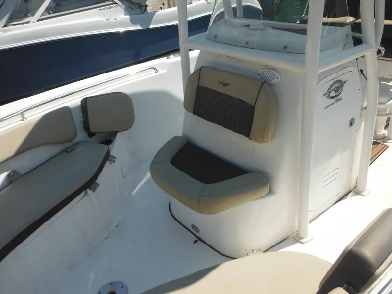 Slide: The Image of 2022 Tidewater 220 LXF boat interior with cushioned seating and console. - 7