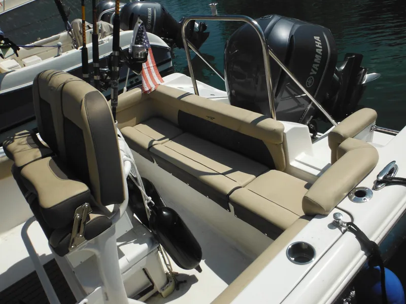 Slide: The Image of 2022 Tidewater 220 LXF boat interior with seating and Yamaha engines. - 9