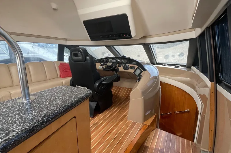 Slide: The Image of Interior of 2000 Carver 530 Voyager Pilothouse with helm, seating, and wood flooring. - 12