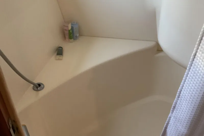 Slide: The Image of Shower area in 2000 Carver 530 Voyager Pilothouse with toiletries and curtain. - 13