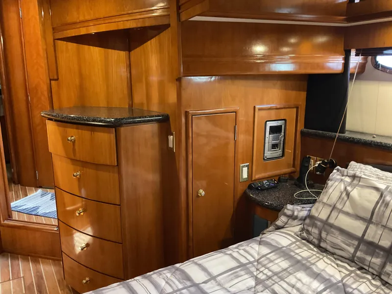 Slide: The Image of Interior of 2000 Carver 530 Voyager Pilothouse with wood cabinetry and plaid bedding. - 15