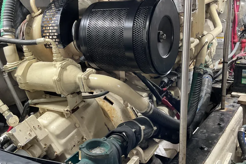 Slide: The Image of Engine room of a 2000 Carver 530 Voyager Pilothouse, showcasing mechanical components. - 22