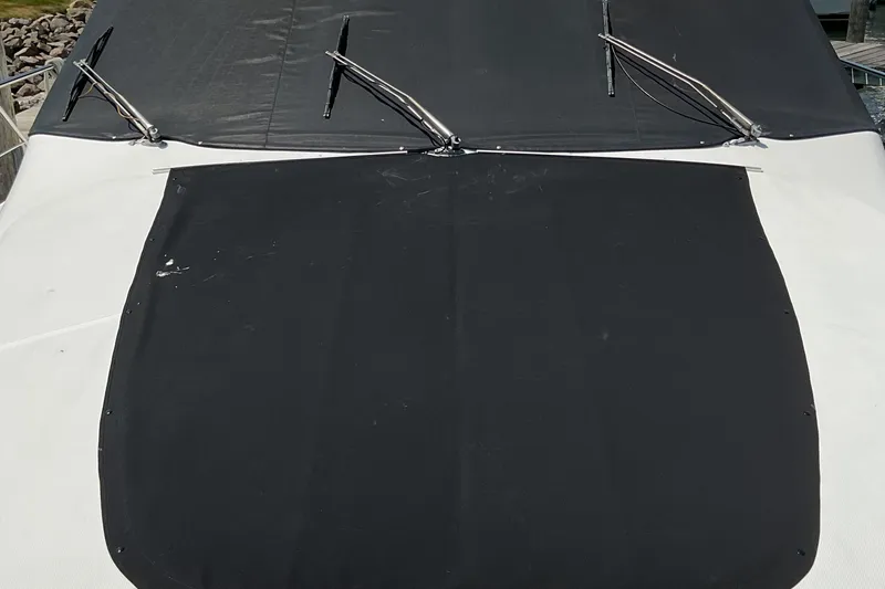 Slide: The Image of 2000 Carver 530 Voyager Pilothouse with black canvas cover and windshield wipers. - 6