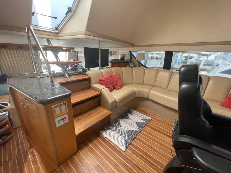 Slide: The Image of Luxurious interior of 2000 Carver 530 Voyager Pilothouse with leather seating and wooden flooring. - 9
