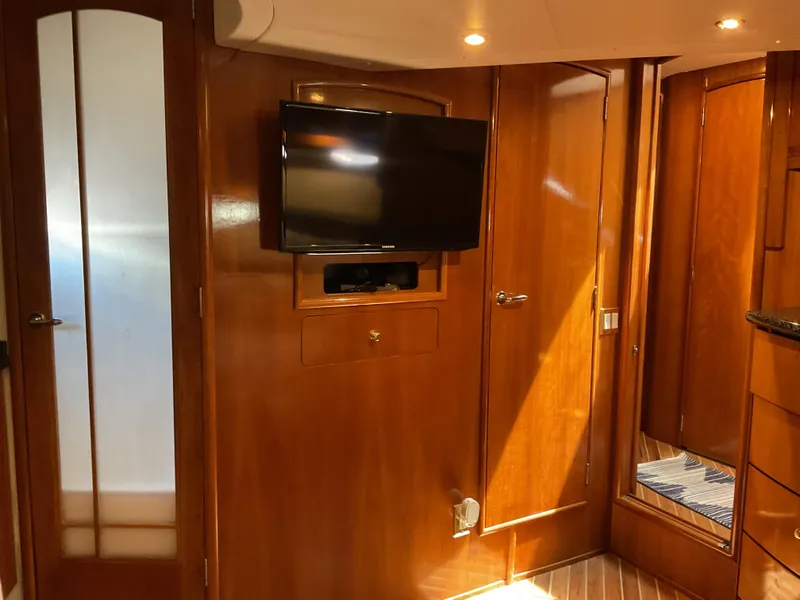 Slide: The Image of Interior of 2000 Carver 530 Voyager Pilothouse with wood paneling and mounted TV. - 14