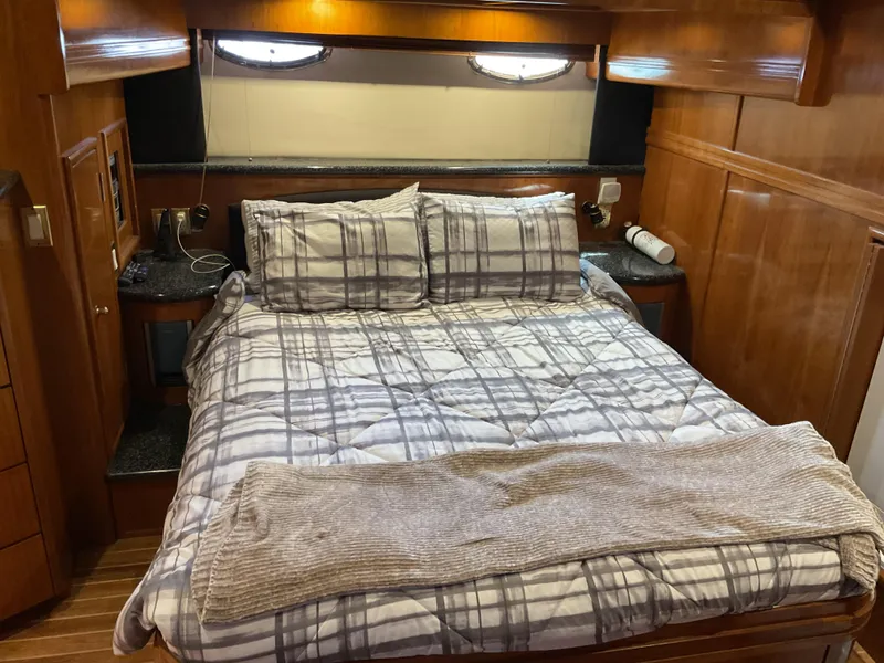 Slide: The Image of Luxurious bedroom interior of 2000 Carver 530 Voyager Pilothouse yacht with plaid bedding. - 19