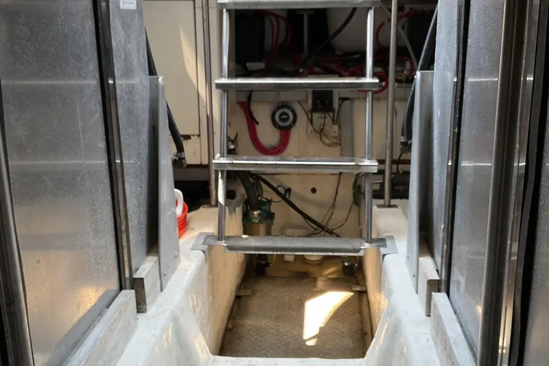 Slide: The Image of Engine room of 2000 Carver 530 Voyager Pilothouse with ladder and equipment. - 21