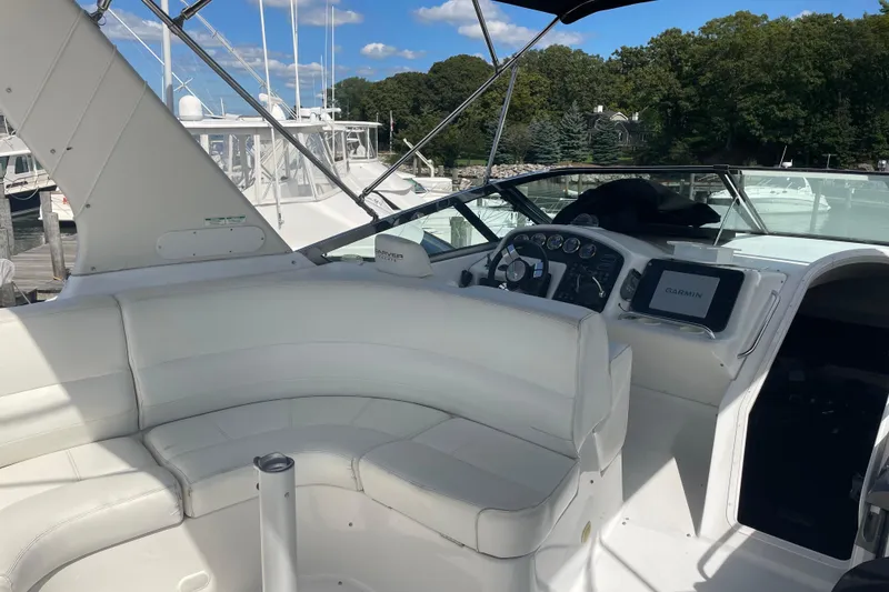 Slide: The Image of 2000 Carver 530 Voyager Pilothouse interior with white seating and navigation equipment. - 29