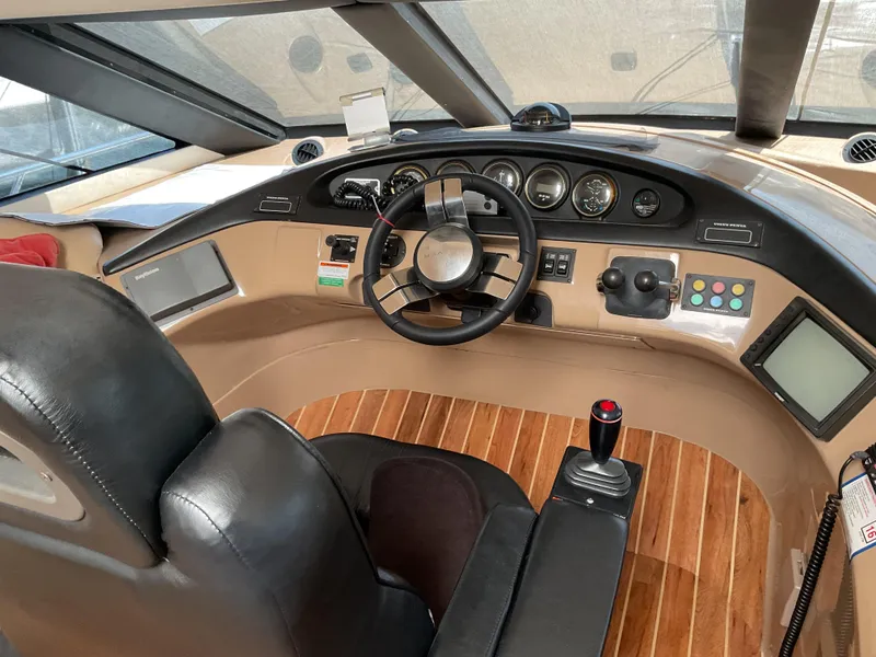 Slide: The Image of Pilothouse interior of 2000 Carver 530 Voyager, featuring steering wheel and control panel. - 8