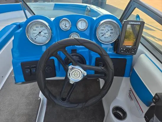 Slide: The Image of 2015 Bryant Sportabout boat dashboard with steering wheel, gauges, and Lowrance GPS system. - 3