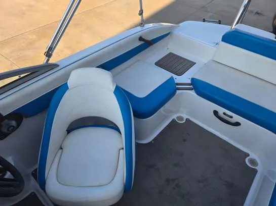 Slide: The Image of 2015 Bryant Sportabout boat interior with blue and white seating. - 5