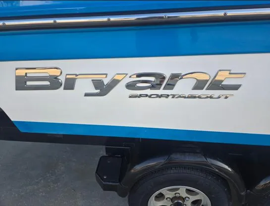 Slide: The Image of 2015 Bryant Sportabout boat with blue and white exterior, showcasing brand logo. - 8