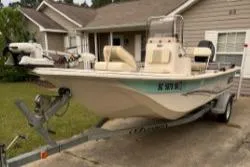 Slide: The Image of 2019 Carolina Skiff 18JVX boat on trailer parked in residential driveway. - 0