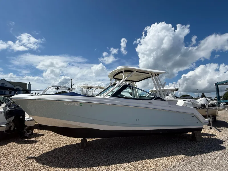 Slide: The Image of 2021 Boston Whaler 240 Vantage boat displayed outdoors under a blue sky. - 0