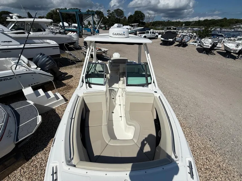 Slide: The Image of 2021 Boston Whaler 240 Vantage boat displayed in a marina with other vessels. - 11