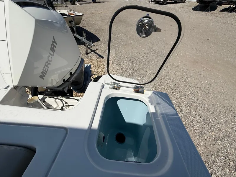 Slide: The Image of Boston Whaler 240 Vantage 2021 boat with Mercury engine and open storage compartment. - 6