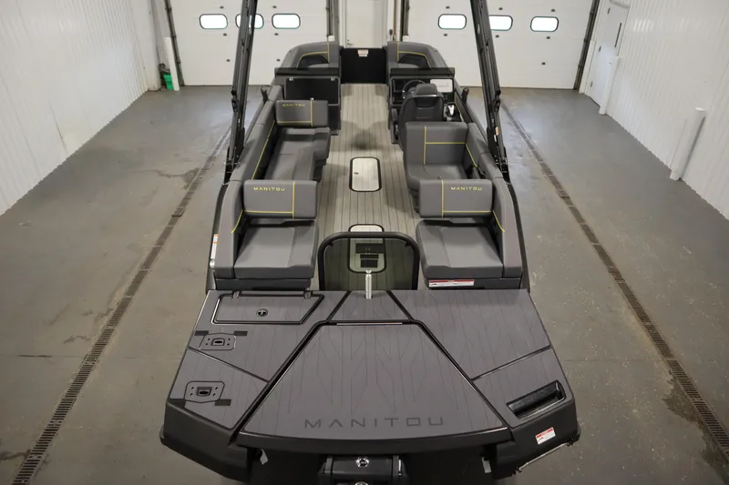 Slide: The Image of 2025 Manitou 24 Explore Switchback Tritoon interior with sleek seating and modern design. - 10
