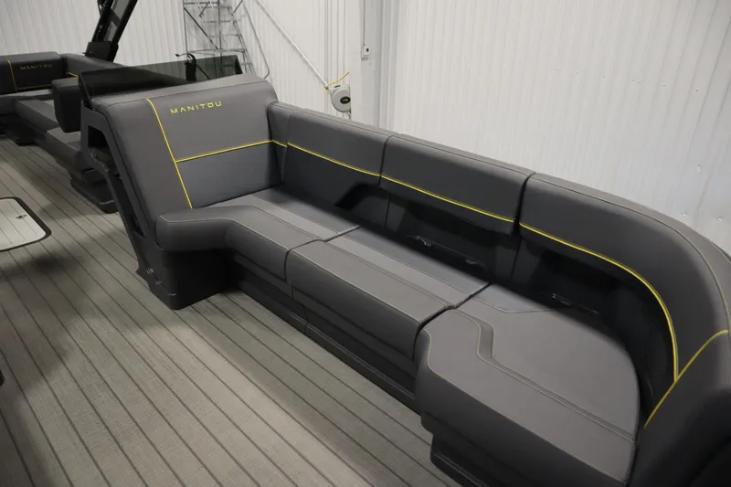 Slide: The Image of 2025 Manitou 24 EXPLORE SWITCHBACK TRIFOLD TRITOON interior with sleek gray seating. - 12