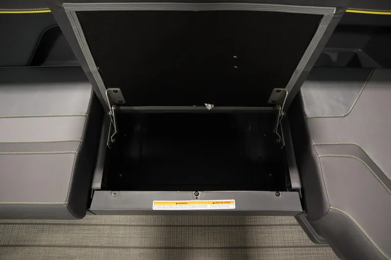 Slide: The Image of Open storage compartment in 2025 Manitou 24 Explore Switchback Trifold Tritoon boat. - 14