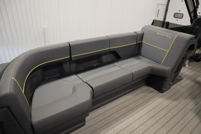 Slide: The Image of Luxurious seating on 2025 Manitou 24 Explore Switchback Trifold Tritoon boat. - 16