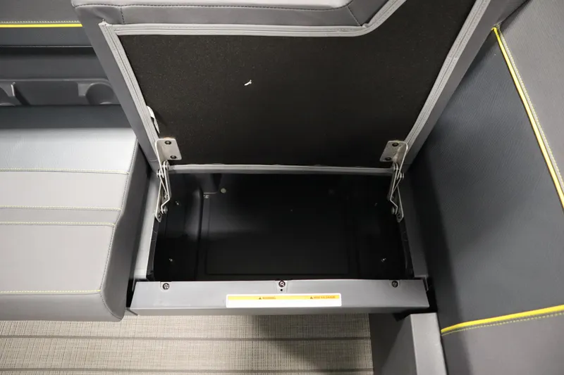 Slide: The Image of Open storage compartment in 2025 Manitou 24 Explore Switchback Trifold Tritoon boat. - 17