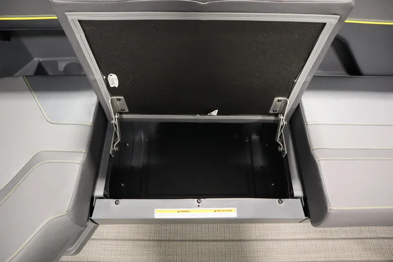 Slide: The Image of Open storage compartment in 2025 Manitou 24 Explore Switchback Trifold Tritoon boat seat. - 18