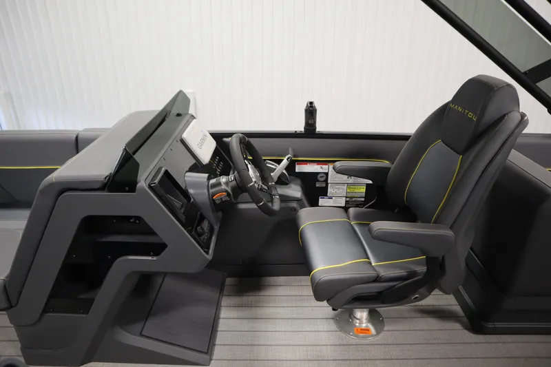 Slide: The Image of 2025 Manitou 24 Explore Switchback Tritoon helm with modern steering and comfortable seating. - 21