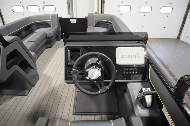 Slide: The Image of 2025 Manitou 24 Explore Switchback Tritoon interior with Garmin navigation system. - 22