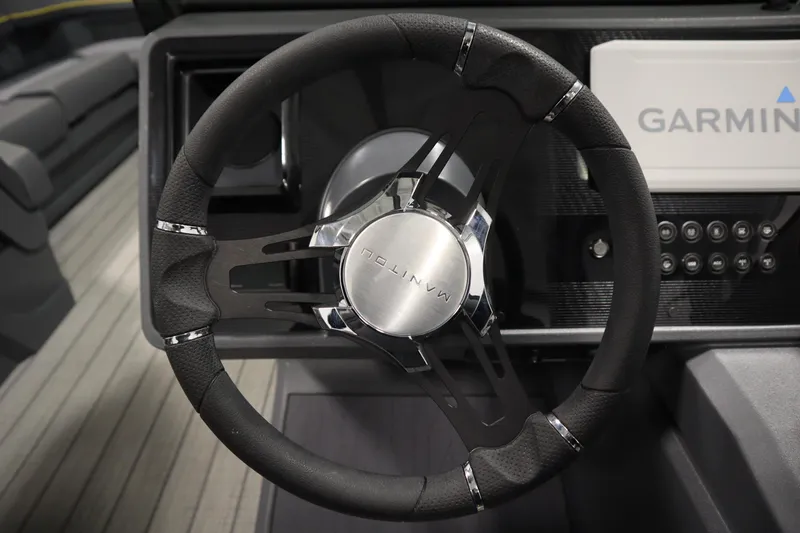 Slide: The Image of Steering wheel of 2025 Manitou 24 Explore Switchback Trifold Tritoon with Garmin display. - 23