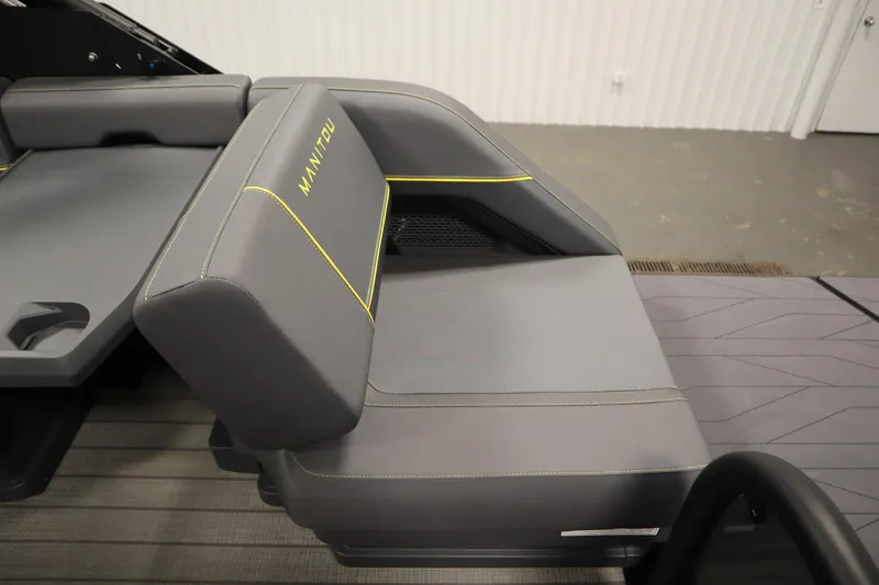 Slide: The Image of 2025 Manitou 24 EXPLORE SWITCHBACK TRIFOLD TRITOON seat with gray upholstery and yellow accents. - 49
