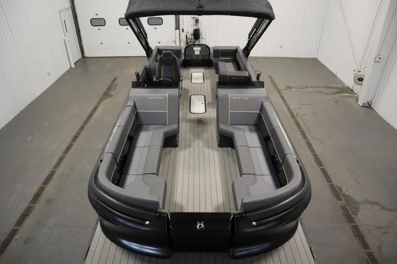 Slide: The Image of 2025 Manitou 24 Explore Switchback Trifold Tritoon with sleek seating and modern design. - 9