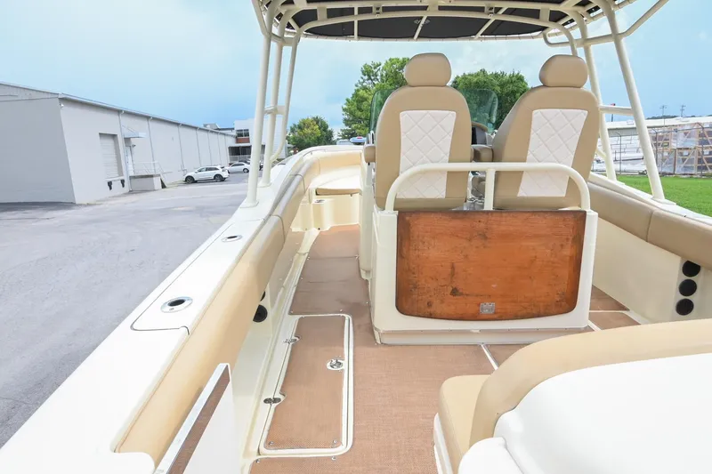 Slide: The Image of 2016 Chris-Craft Catalina 29 boat interior with beige seating and helm station. - 14
