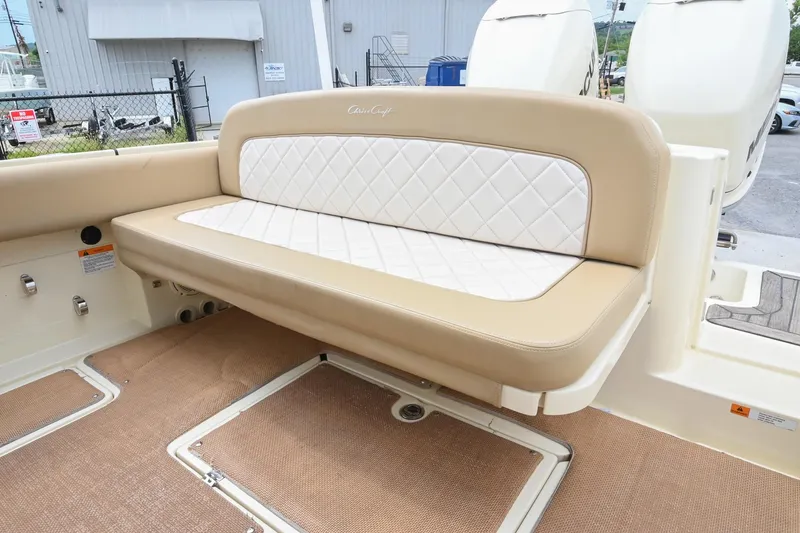 Slide: The Image of 2016 Chris-Craft Catalina 29 boat interior with beige and white cushioned seating. - 15