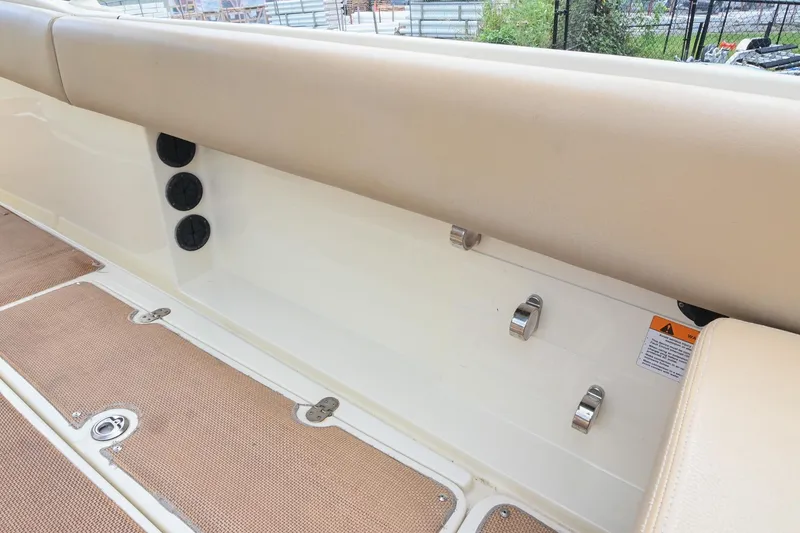 Slide: The Image of 2016 Chris-Craft Catalina 29 interior detail with beige seating and deck fittings. - 16