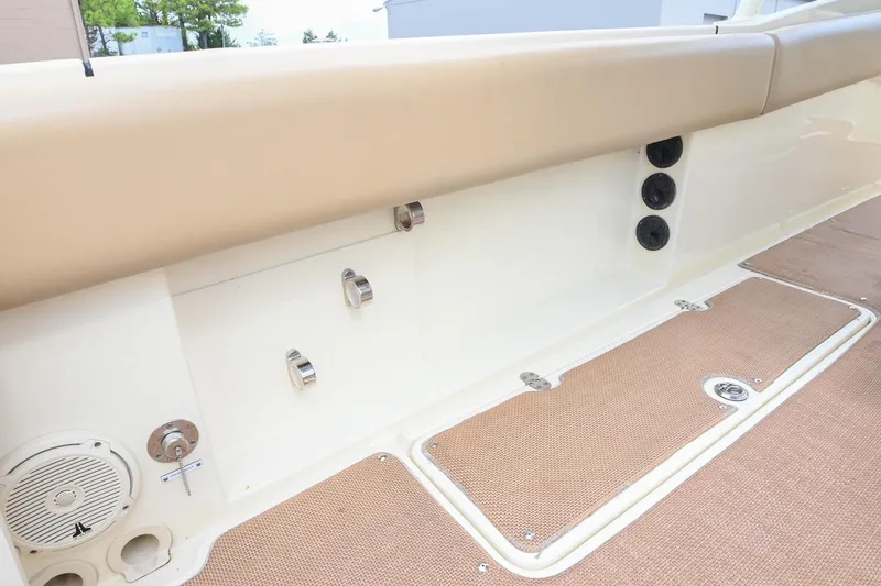 Slide: The Image of 2016 Chris-Craft Catalina 29 interior with beige seating and carpeted flooring. - 18