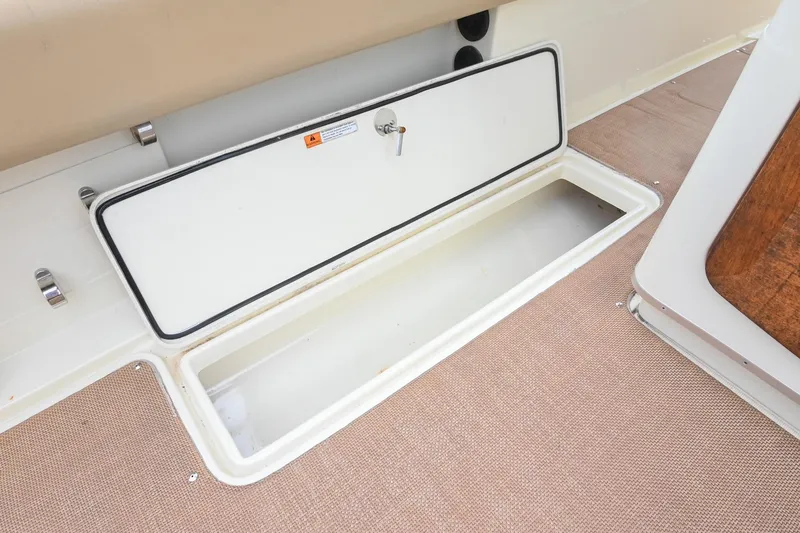 Slide: The Image of 2016 Chris-Craft Catalina 29 storage compartment with open hatch on deck. - 19