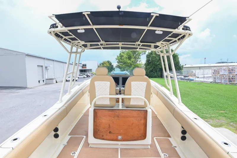 Slide: The Image of 2016 Chris-Craft Catalina 29 boat interior with seating and canopy, parked outdoors. - 20