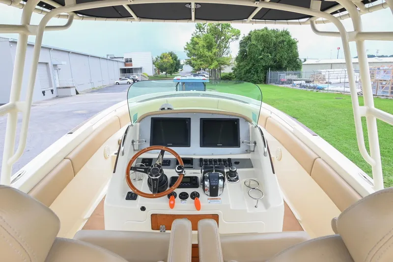 Slide: The Image of 2016 Chris-Craft Catalina 29 boat cockpit with steering wheel and dual screens. - 27