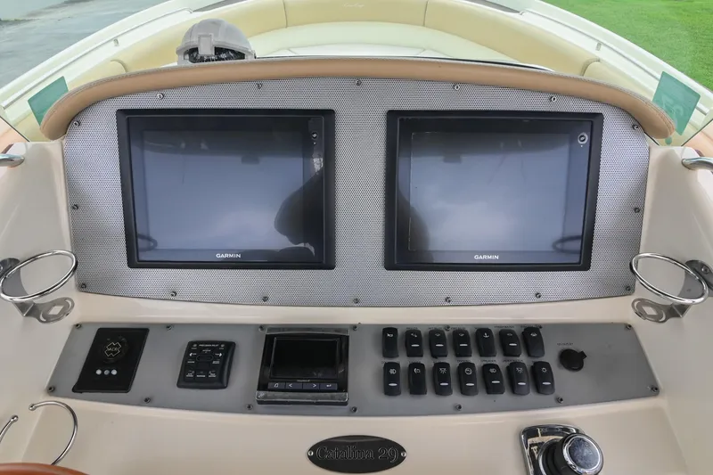Slide: The Image of 2016 Chris-Craft Catalina 29 dashboard with dual Garmin displays and control panel. - 29